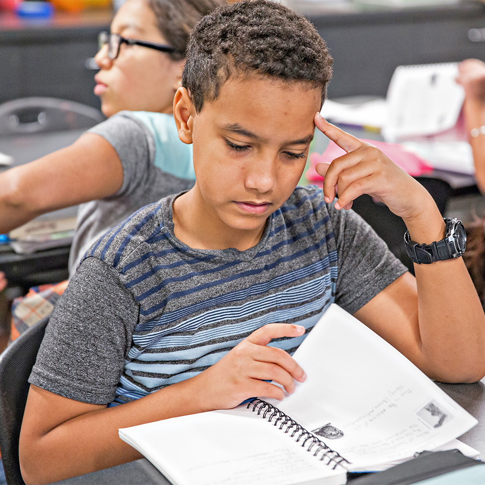 Student reading a book at BASIS Goodyear Charter School