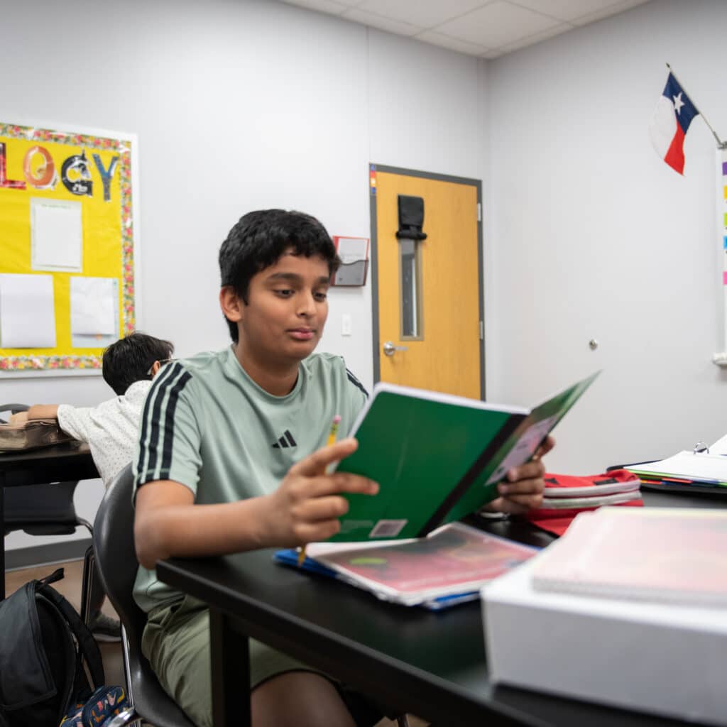 Student reading book in biology class