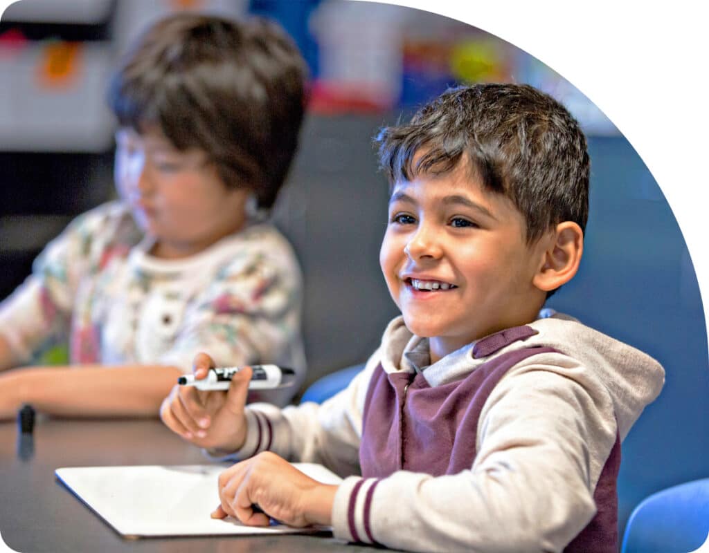 Young_kid_in_class_paying_attention_at_desk