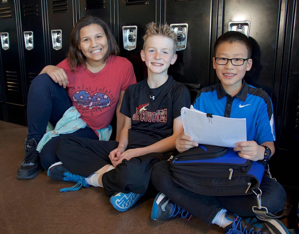 kids-sitting-in-front-of-lockers-on-floor-scaled.jpg