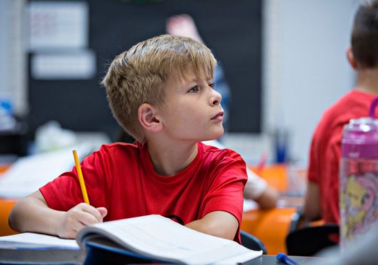 Young student writing in notebook